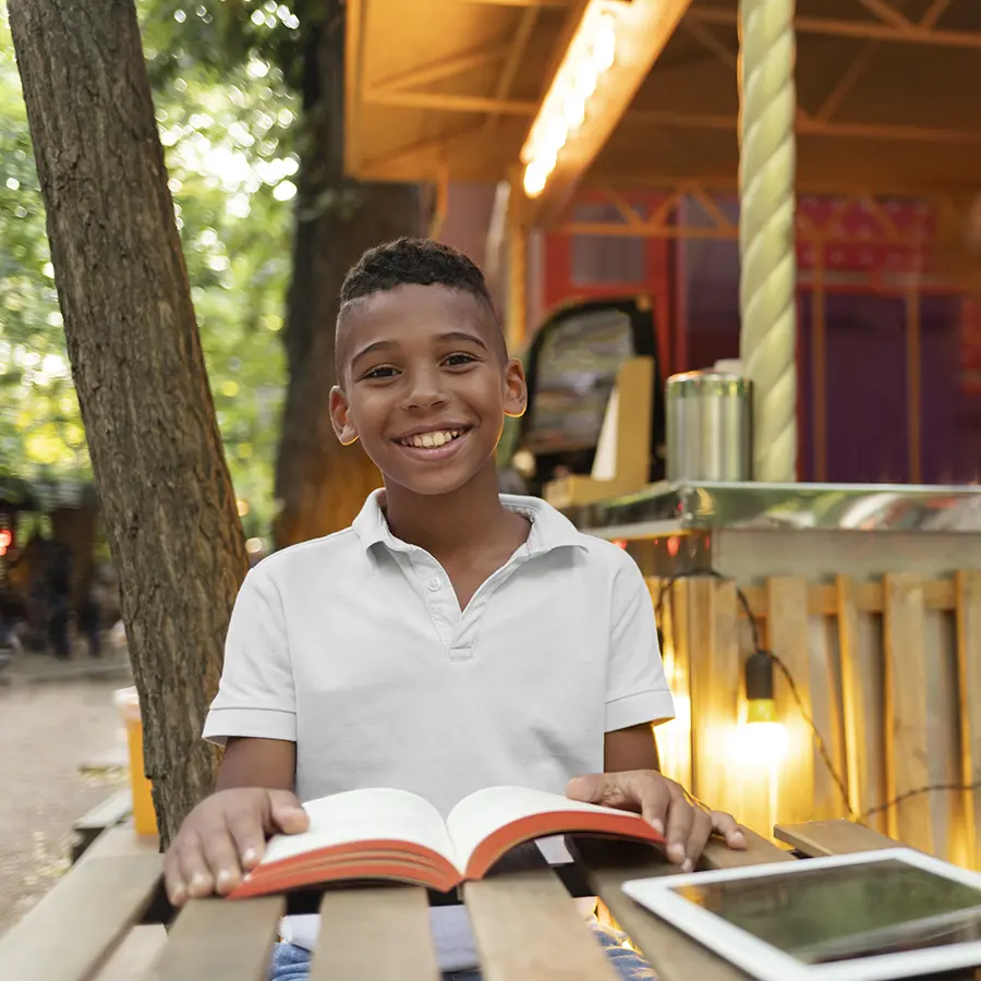 Kid reading a book and smiling